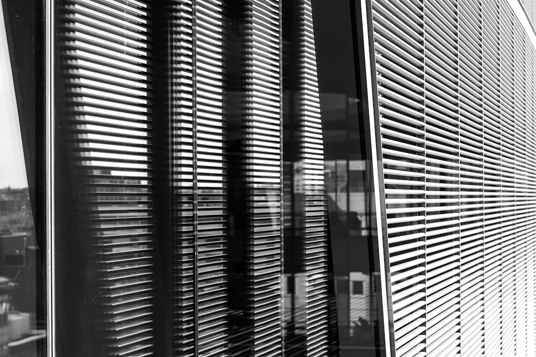 A person gazing out a hospital window with a look of quiet hope and determination