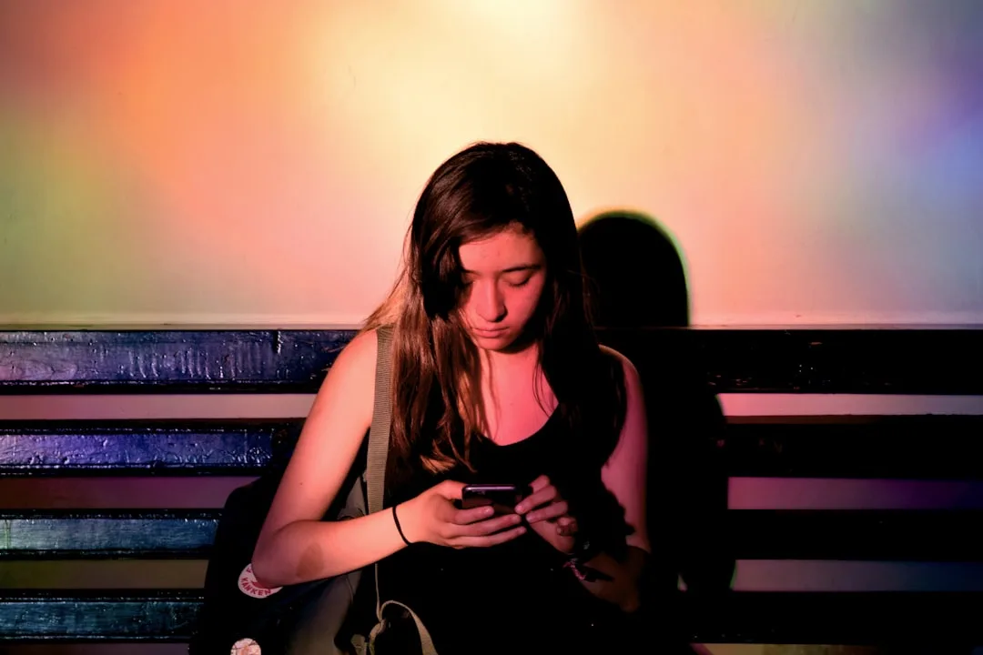angry person looking at phone candid natural lighting moody emotional tension