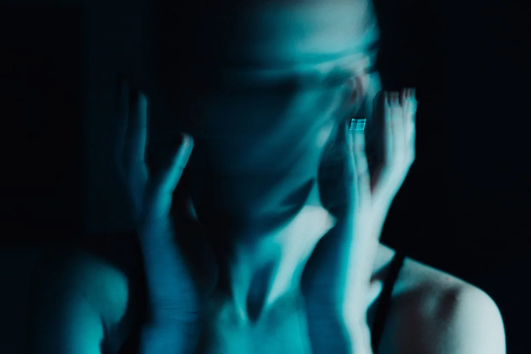 despair woman head in hands candid natural lighting moody emotional tension