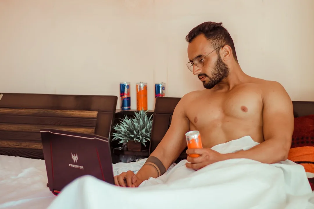 stressed man with laptop medical bills moody natural lighting candid