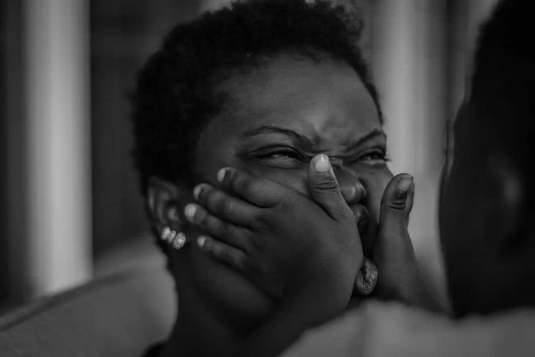 wife crying covering face natural lighting moody emotional tension