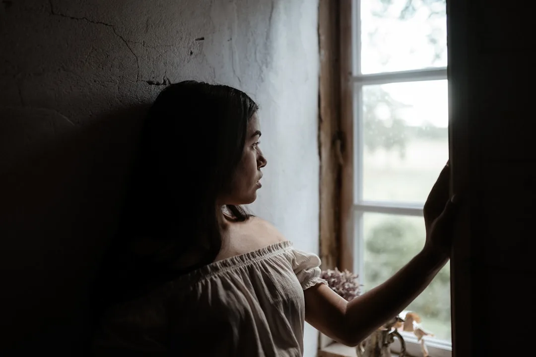 looking out window hopeful candid natural lighting moody